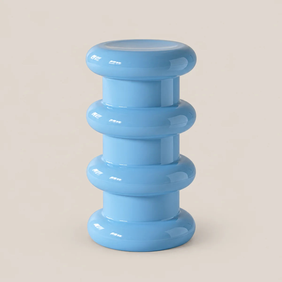 A light blue modern pedestal stool with a stacked, ribbed circular design, shown on a solid beige background.