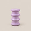A small lavender purple side table with a glossy finish, featuring a stacked, rounded tiered design on a solid beige background.