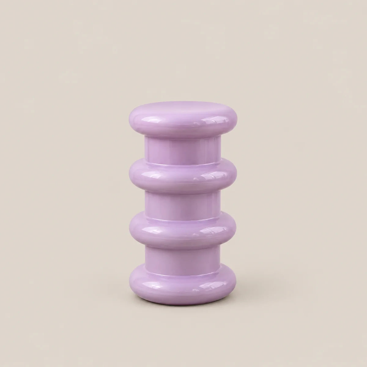A small lavender purple side table with a glossy finish, featuring a stacked, rounded tiered design on a solid beige background.