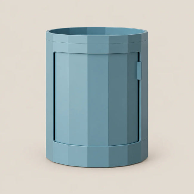 A modern, faceted cylindrical storage container in a muted blue-gray color, shown on a solid light beige background.