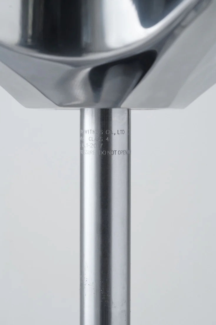 Close-up of a metal ladle with a blurred background