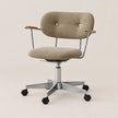 A modern office chair with a textured beige fabric upholstered seat and backrest, featuring a tufted backrest, wooden armrests, and a chrome five-star base with black casters, set against a solid light beige background.