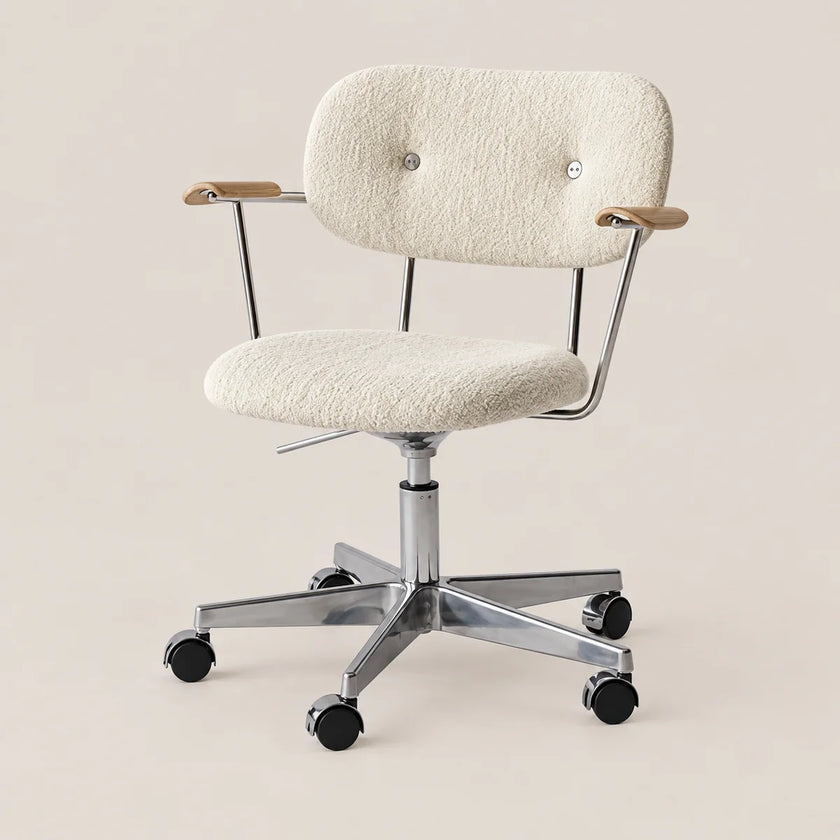An adjustable office chair with a textured cream bouclé upholstered seat and backrest, chrome metal frame and base, and light wood armrest caps, shown on a plain beige background.
