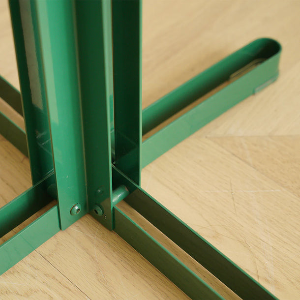 Green metal frame on a wooden floor