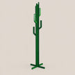 A modern cactus-shaped coat rack made of glossy green metal, featuring a vertical trunk with branching arms and a four-legged base, shown against a solid light beige background.