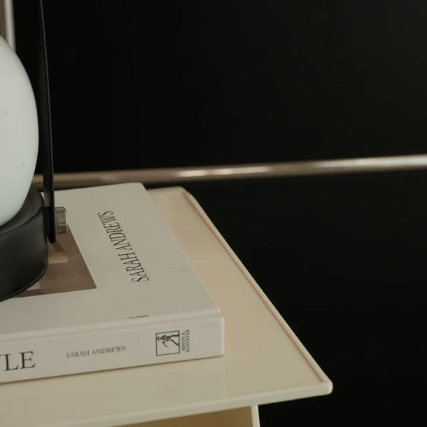 The top shelf of the Wave Cart features raised edges to prevent items from sliding off.