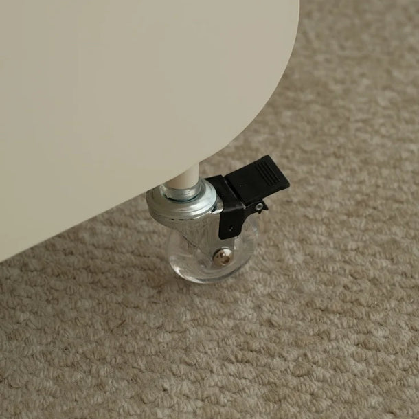 Close-up of a chair leg with a black clip on a beige carpet