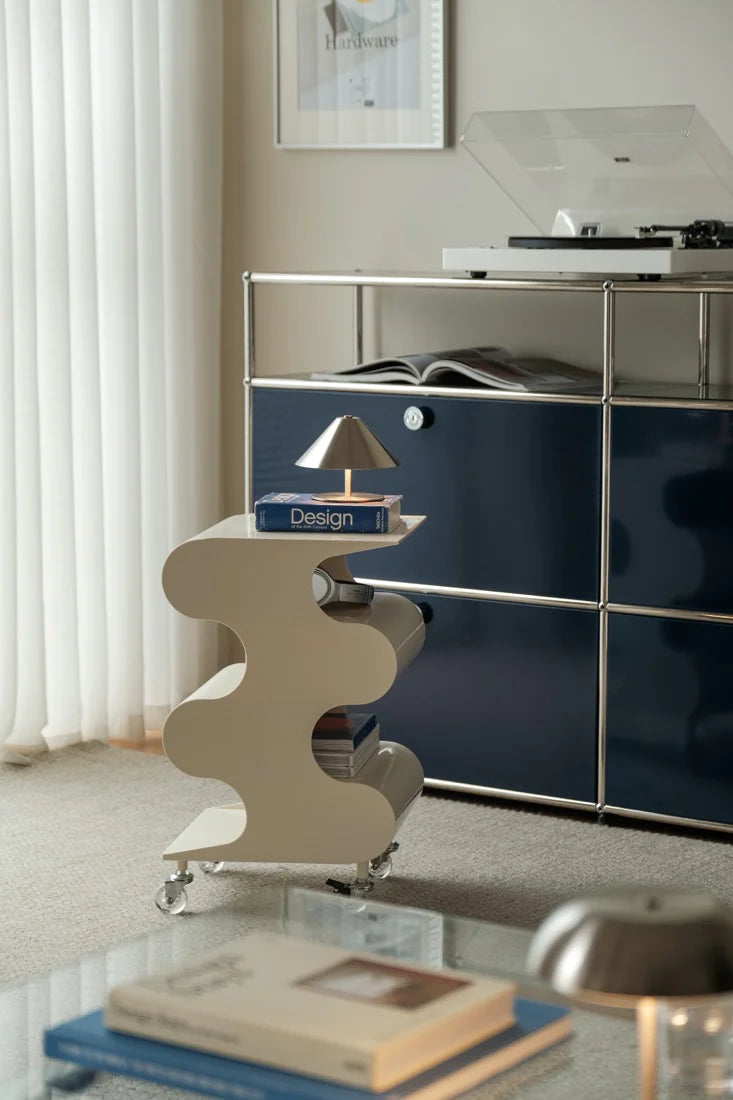 Modern interior with a sideboard, decorative shelf, and books.