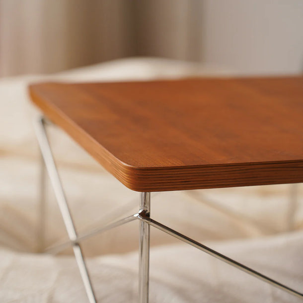 Wooden table with metal legs on a soft, blurred background