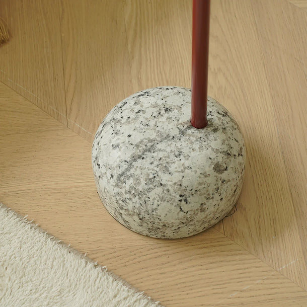 Concrete base with a red pole on a wooden floor