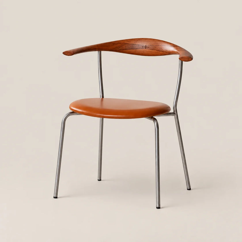 A mid-century modern dining chair featuring a curved wooden armrest and backrest, a matching contoured seat cushion, and a slim tubular steel frame, shown against a solid light beige background.