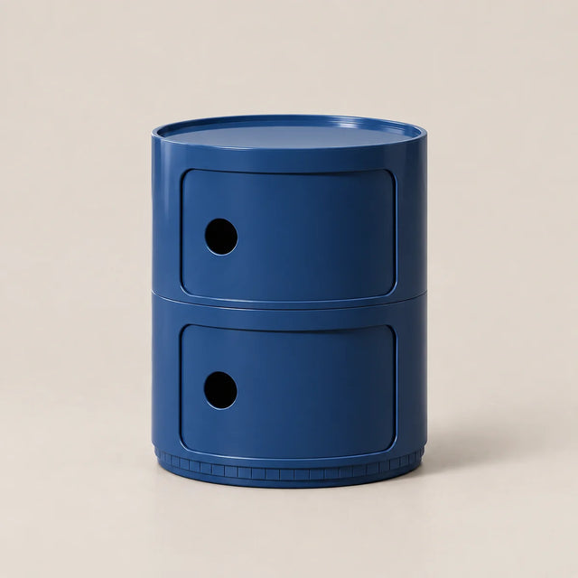 A two-tier blue plastic organizer with circular drawer fronts and small circular cutouts, set against a solid light beige background.
