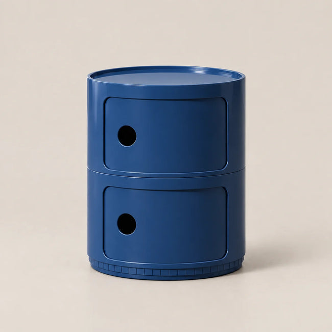 A two-tier blue plastic organizer with circular drawer fronts and small circular cutouts, set against a solid light beige background.