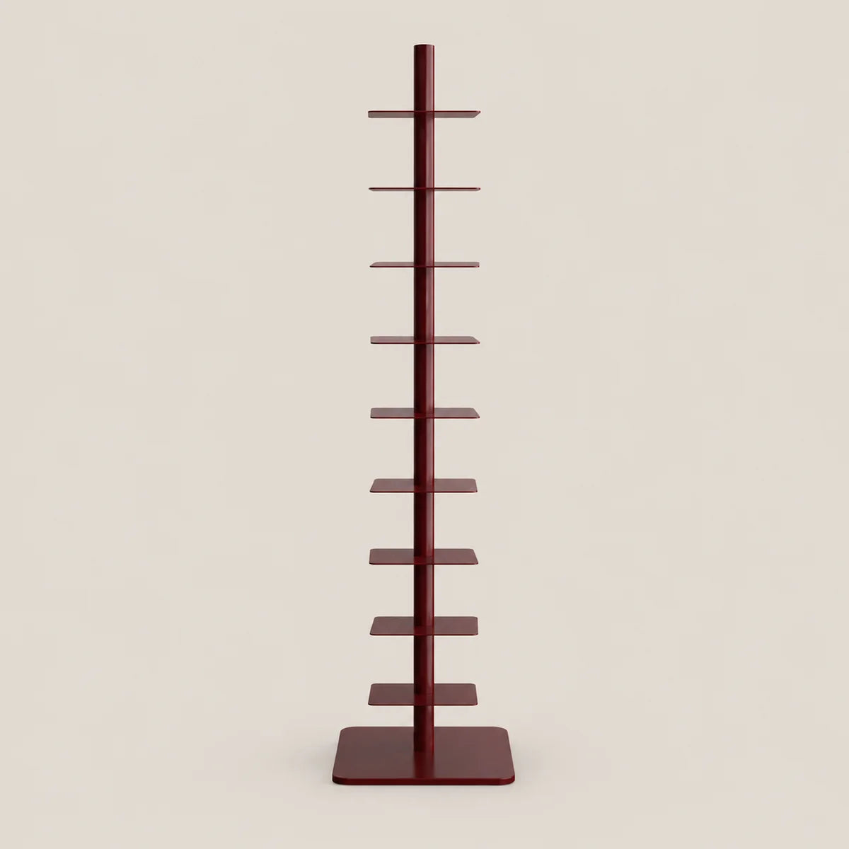 A tall, narrow multi-tier display stand with a central vertical pole and multiple flat horizontal shelves, finished in a dark reddish-brown color, set against a solid light beige background.