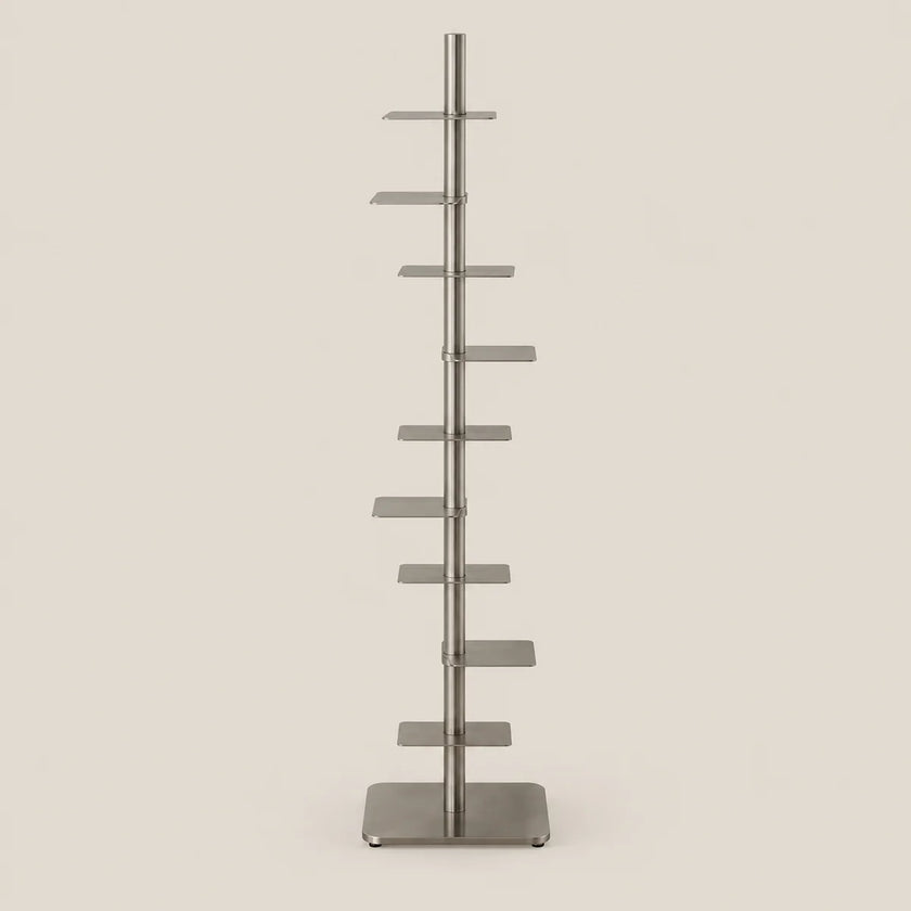 A tall, slim metal display stand with multiple horizontal shelves on a vertical pole, shown against a plain light beige background.