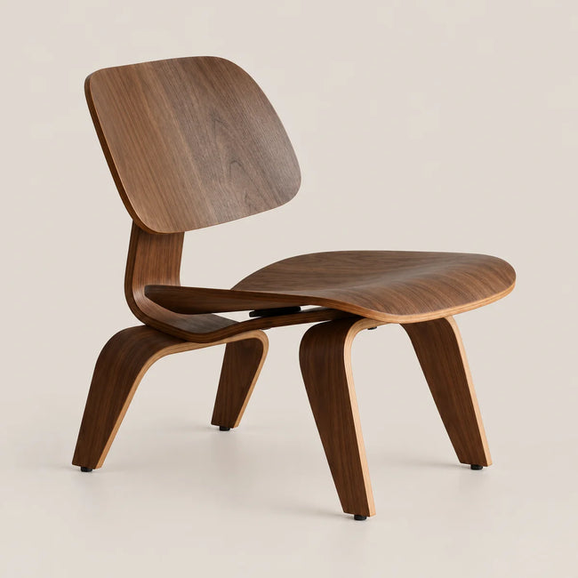 A mid-century modern wooden lounge chair with a curved plywood shell seat and backrest, shown on a clean, light beige background.