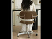 A modern swivel office chair with brown upholstered cushions, a chrome metal frame, and a wheeled base.