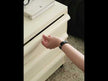 A sleek white mobile drawer unit with five drawers, set on black wheels, offering a simple and modern look.