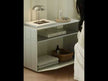 A minimalist open shelving unit with two tiers, featuring a sturdy metal frame and clean, straight edges, typically used as a modern side table or low bookcase for displaying books and decorative items.