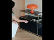 A black modular TV cabinet featuring multifunctional storage space, equipped with drop-down doors fitted with soft-close mechanisms for silent operation.