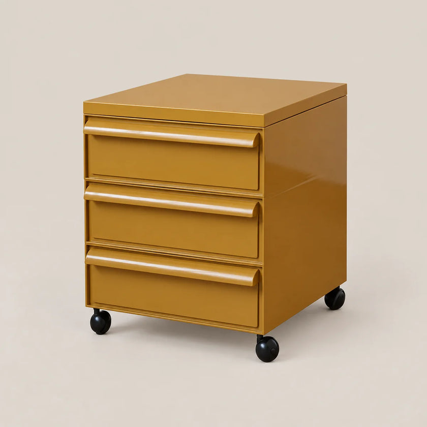 A three-drawer rolling file cabinet in a glossy mustard yellow finish with black casters, shown on a solid light beige background.