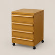 A mustard yellow five-drawer rolling file cabinet with black caster wheels, shown on a solid light beige background.