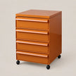 An orange plastic rolling file cabinet with five drawers and black caster wheels, photographed on a neutral light beige background.