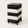 A 5-drawer rolling storage cabinet with a black and cream striped design, featuring black drawer fronts and handles, cream drawer sides, and black caster wheels, shown on a light beige background.