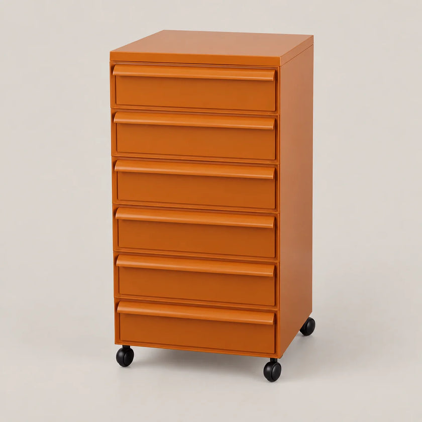 An orange plastic rolling file cabinet with six drawers and black caster wheels, photographed on a neutral light gray studio background.