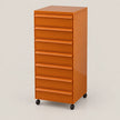 An orange rolling file cabinet with eight drawers and black caster wheels, photographed on a clean light gray studio background.