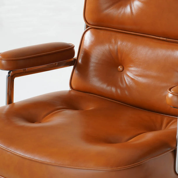 Close-up of a brown leather armchair with a white background
