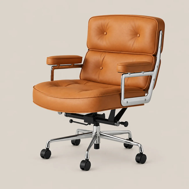 A mid-century modern office chair with tufted cognac brown leather upholstery and a chrome-finished metal frame and five-wheel base, shown against a solid light beige background.
