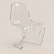 A modern transparent acrylic dining chair with a curved sculptural design, shown on a solid light beige background.
