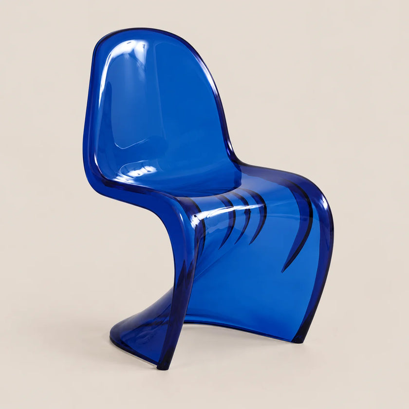 A translucent blue molded chair with a sculptural curved silhouette, photographed against a plain warm beige studio background.