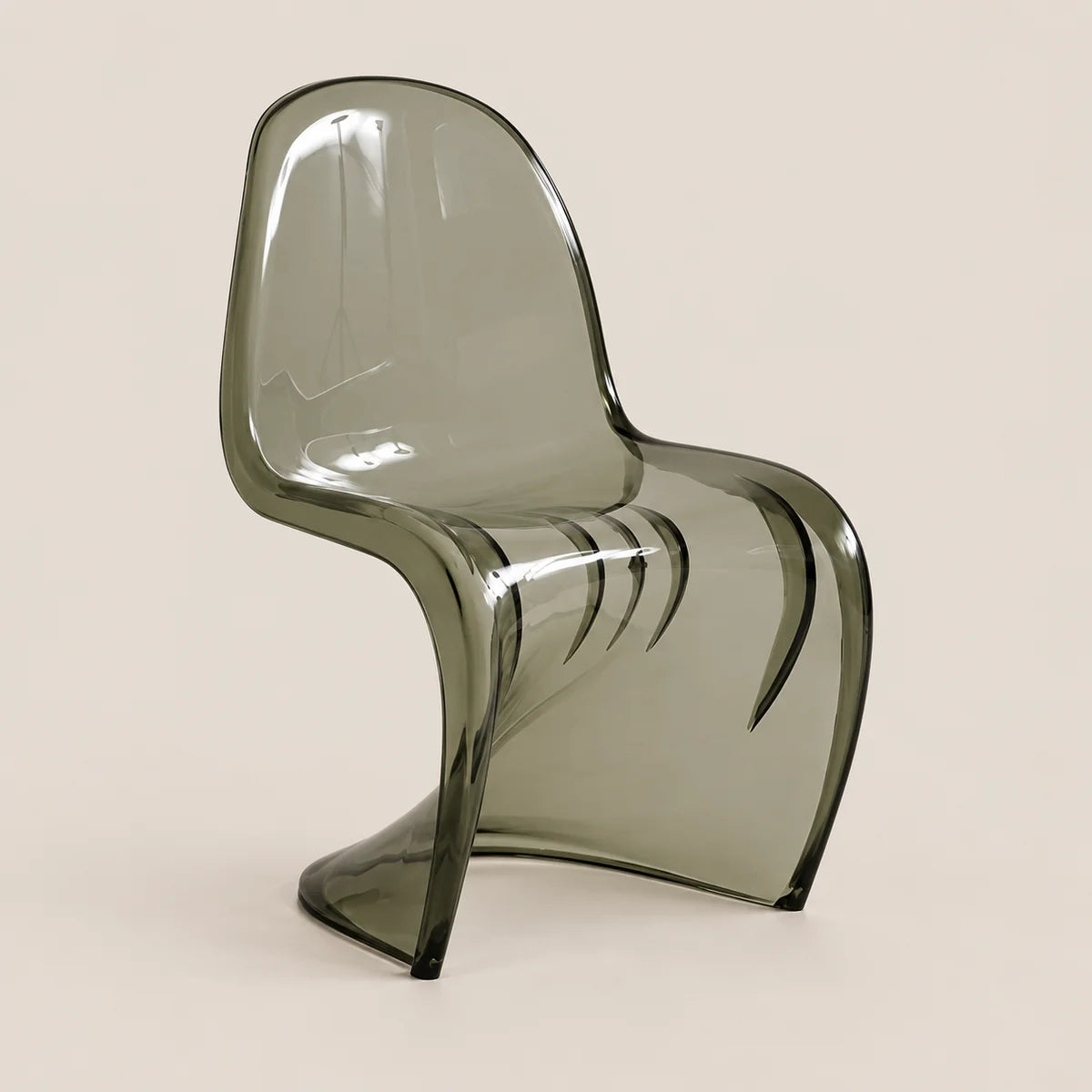A modern translucent smoked gray plastic chair with a curved ergonomic design, shown against a solid light beige background.