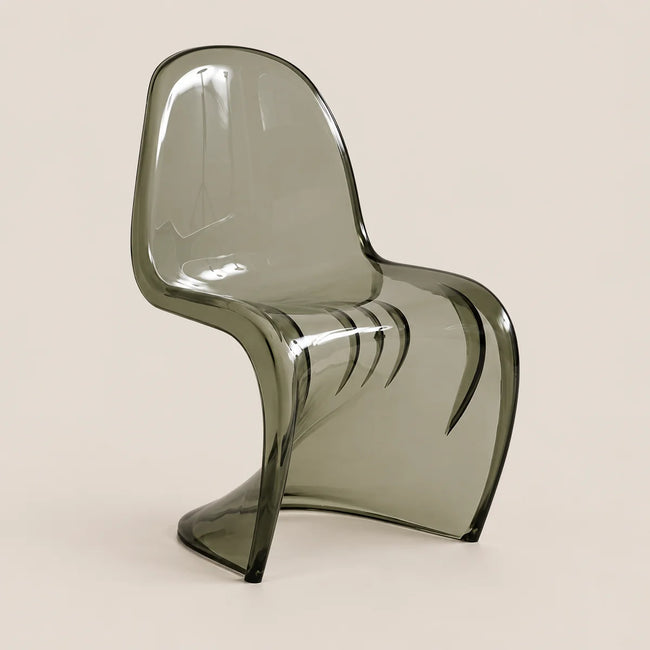 A modern translucent smoked gray plastic chair with a curved ergonomic design, shown against a solid light beige background.