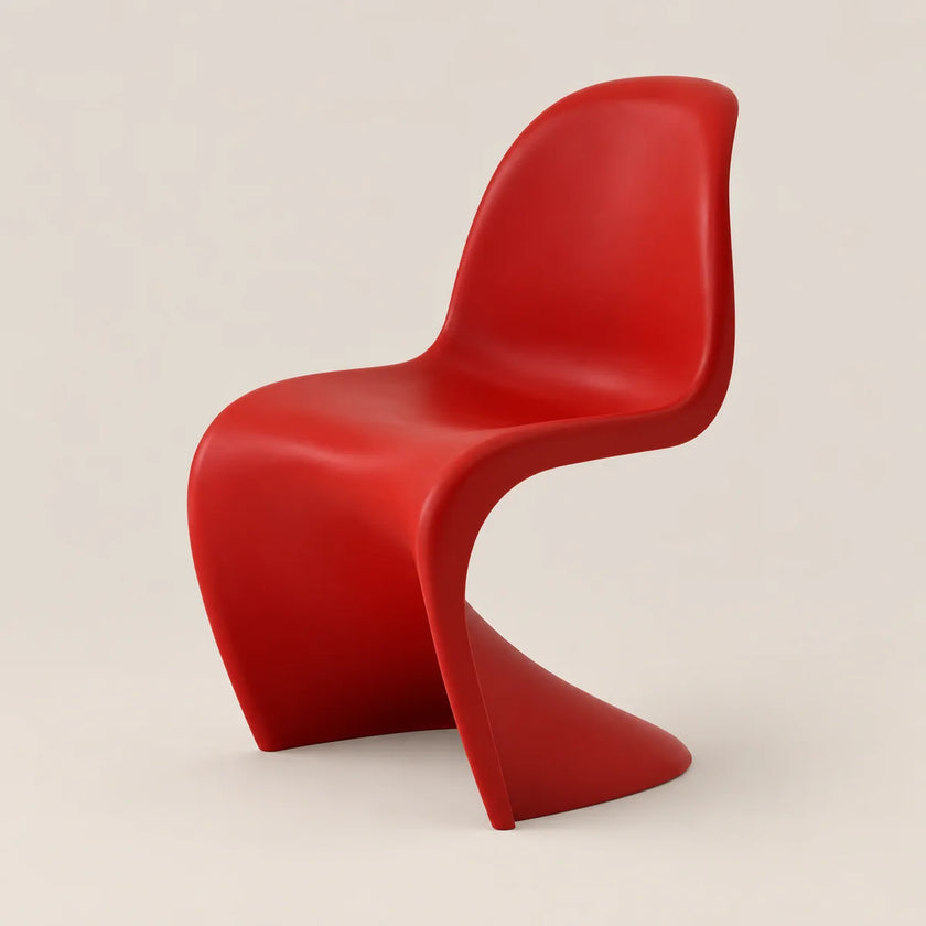 A modern red molded plastic chair with a curved, sculptural design, shown against a solid light beige background.