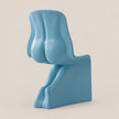 A light blue sculptural chair with an abstract, organic shape, photographed against a solid, warm off-white background.