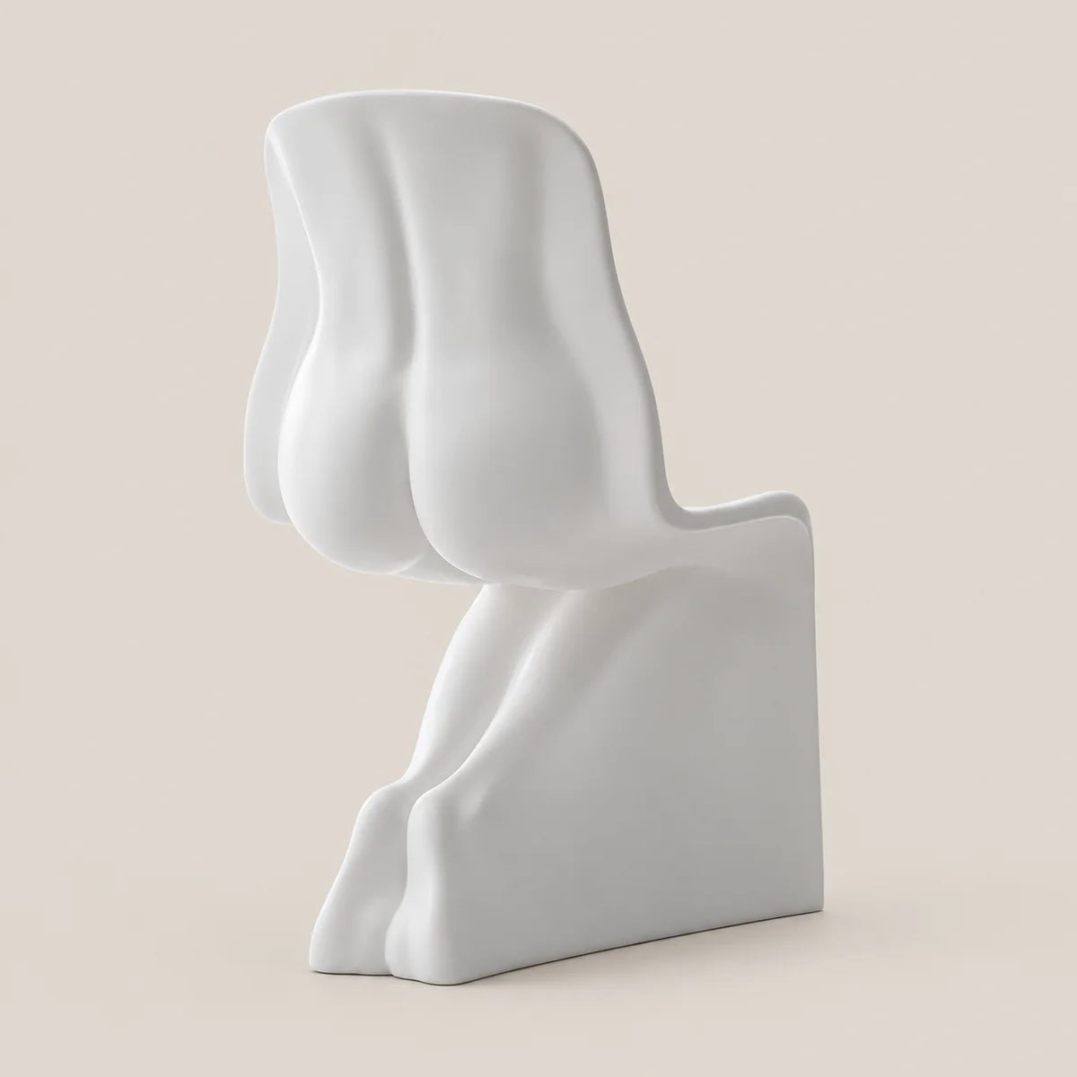 A minimalist, sculptural white chair with an abstract, organic shape, shown from a side profile against a solid, warm beige background.