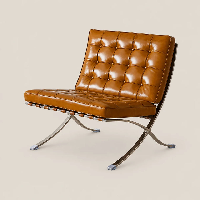 A modern leather armchair with a tufted backrest and seat, supported by a chrome X-frame base, shown against a solid light beige background.