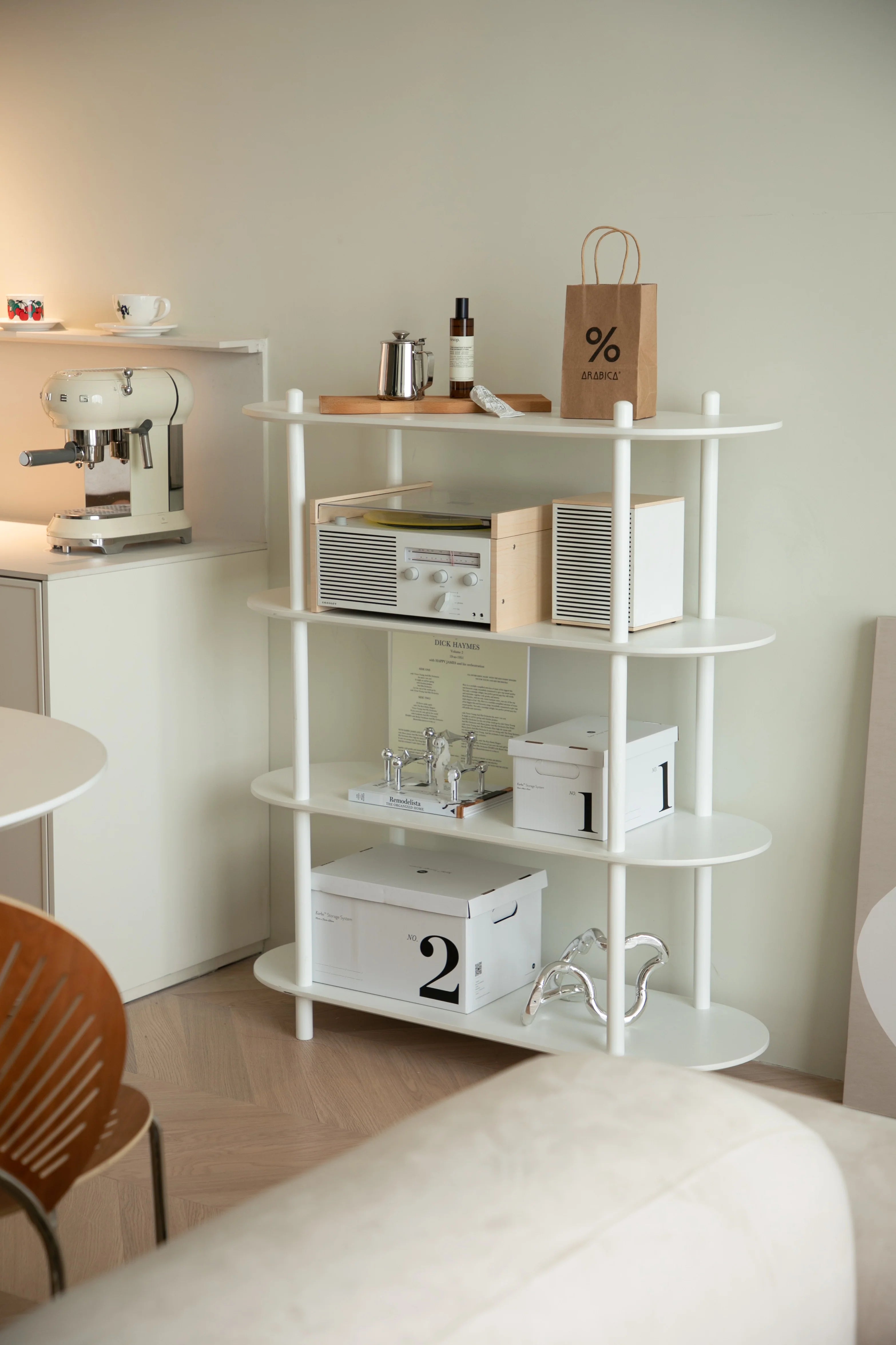 White shelving unit with various items in a room setting