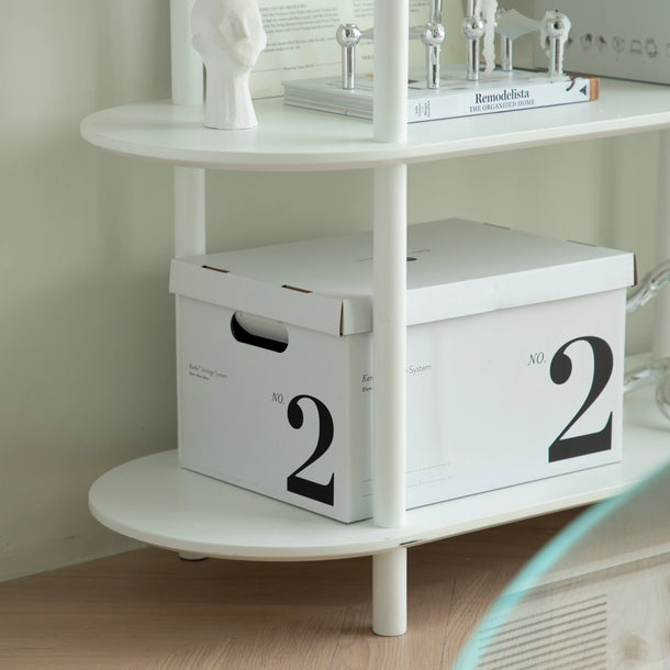 White storage boxes with the number '2' on a shelf against a light wall.