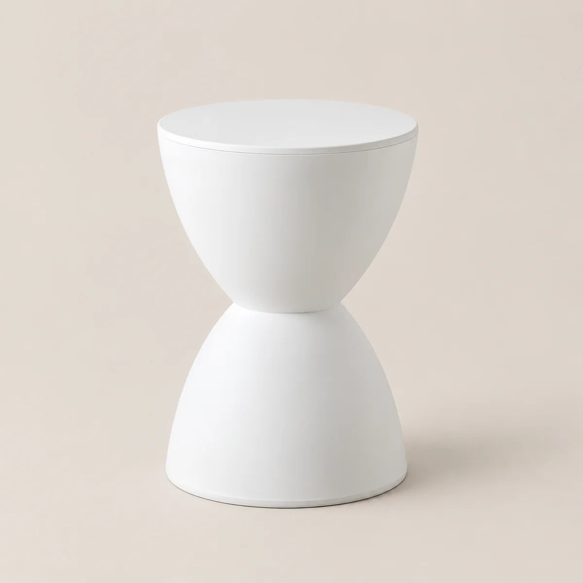 A minimalist white hourglass-shaped side table or stool with a smooth matte finish, set against a solid light beige background.