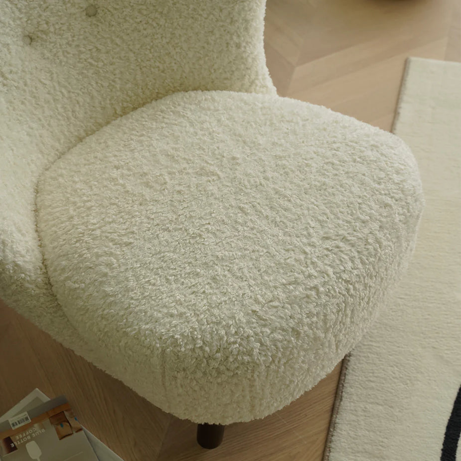 Close-up of a fluffy green chair with a blurred background