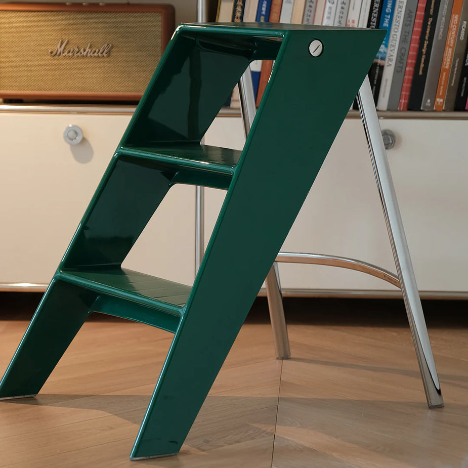 Green step ladder in a room with books and a Marshall amplifier.