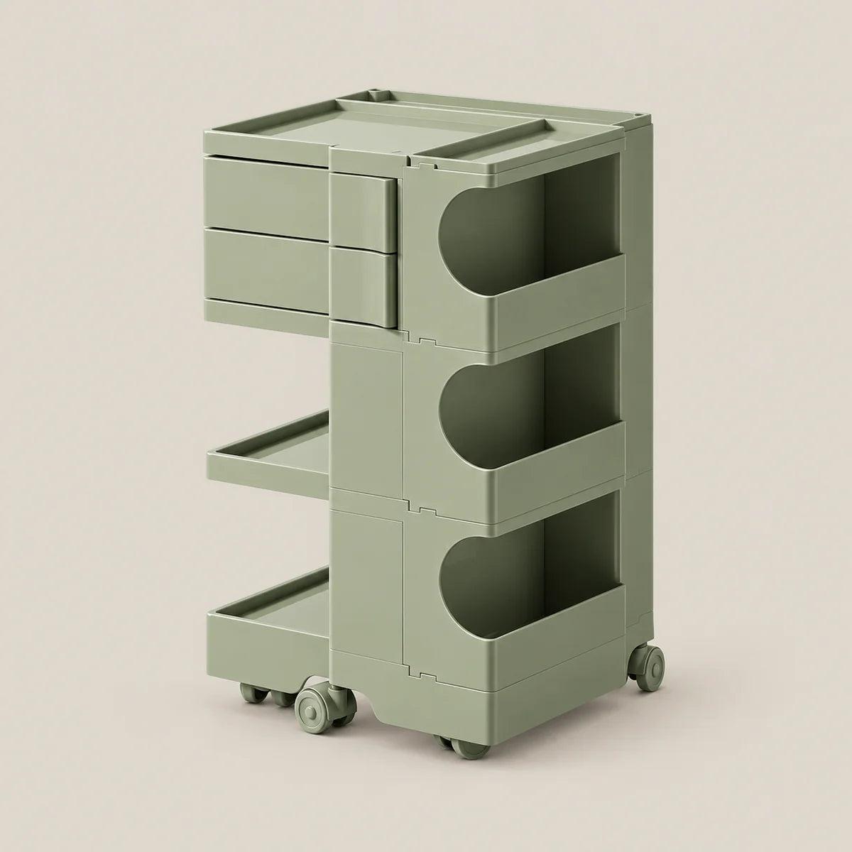 A three-tier rolling storage cart in a muted sage green color, featuring three drawers on the top level, open shelves in the middle, and a lower tray on wheels, set against a solid light beige background.