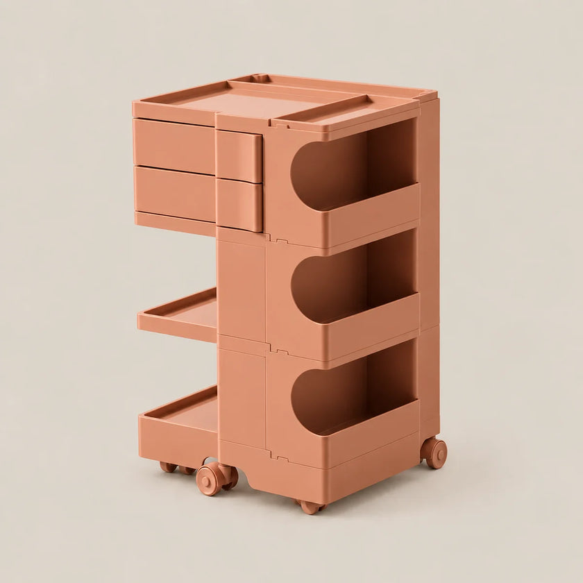 A terracotta-colored plastic rolling storage cart with three drawers, open shelves, and wheels, shown on a solid light beige background.