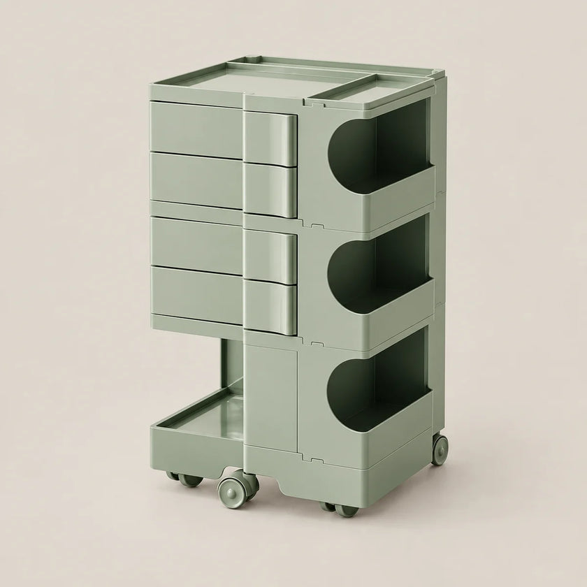 A modern three-tier rolling storage cart in a muted sage green color, featuring three drawers on the left and open storage compartments on the right, set against a solid light beige background.