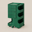 A dark green modular plastic storage cart with five drawers on the left, three open storage compartments on the right, and caster wheels at the base, shown on a solid beige background.