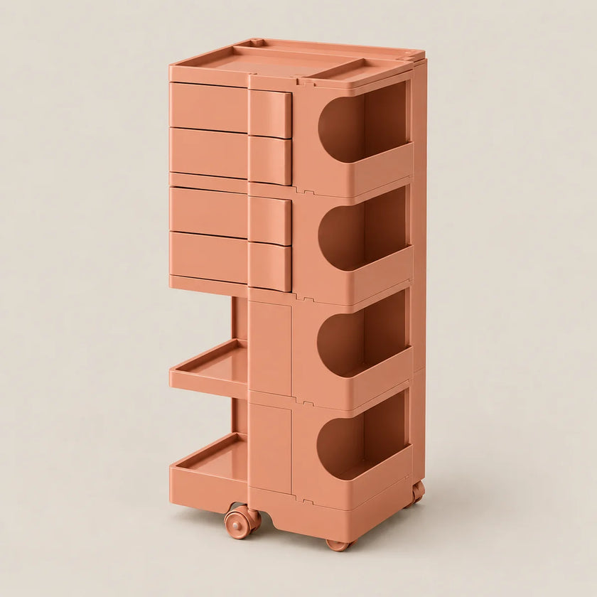 A tall, minimalist rolling storage cart in a warm terracotta or rose-brown color, featuring multiple drawers, open storage compartments, and lower pull-out trays on wheels, set against a solid light beige background.